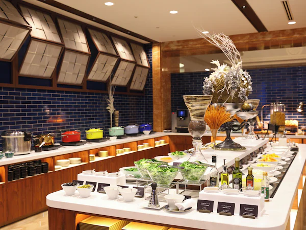 A buffet setup with various food items and condiments.