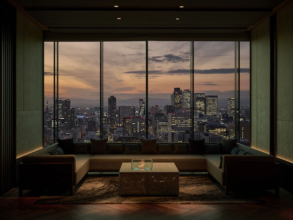 A modern living room with a large window offering a cityscape view.